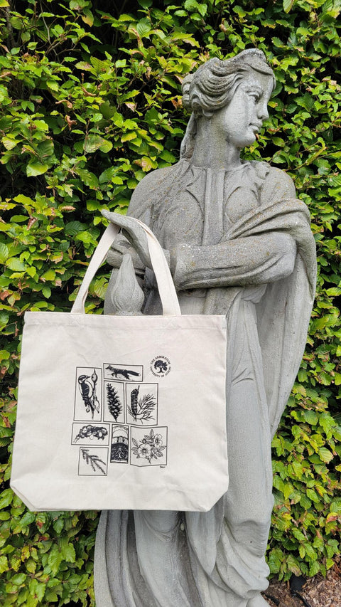 image of sketches bag hanging from hand of statue in garden